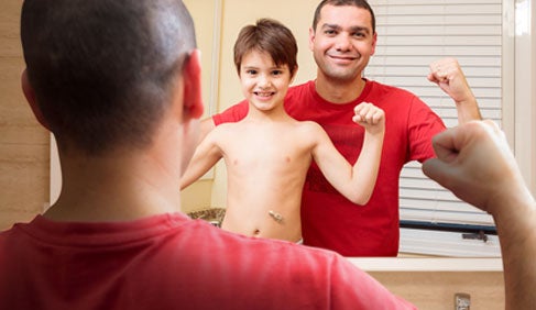 kid with father at the mirror